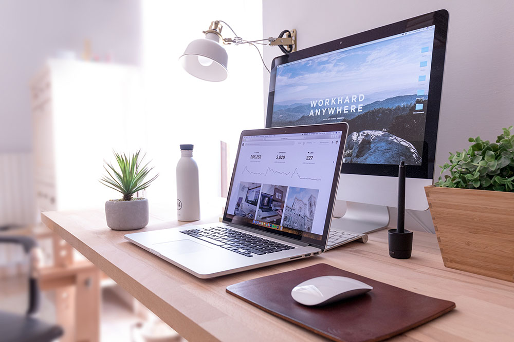 two computers and a laptop on a table